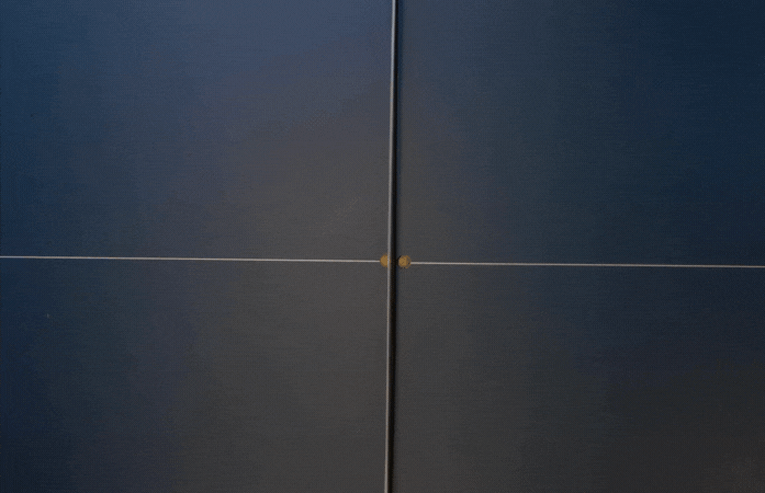 A  ping pong ball going back and forth across ping pong table